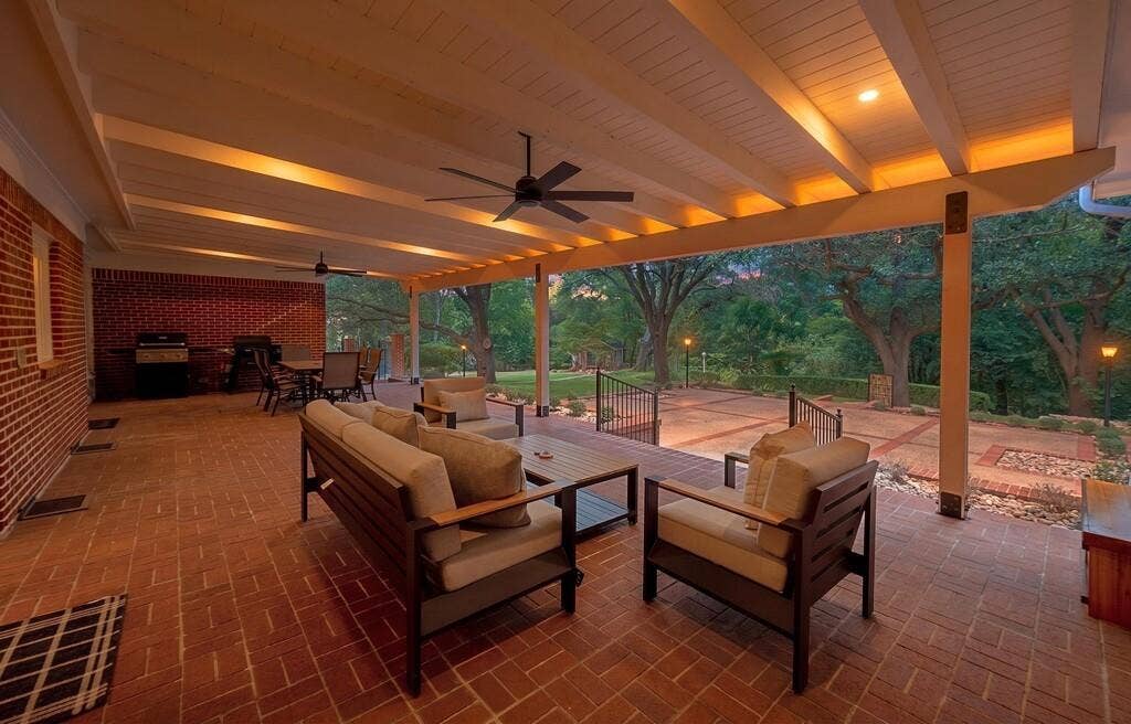 2825 Lake Air Drive, Waco, TX 76710 Expansive covered patio featuring brick-laid flooring, exposed beam ceiling with recessed lighting, and dual ceiling fans