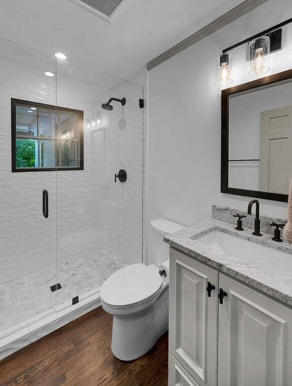 2825 Lake Air Drive, Waco, TX 76710 Full bathroom featuring a walk-in shower with clear glass enclosure and a black-framed window