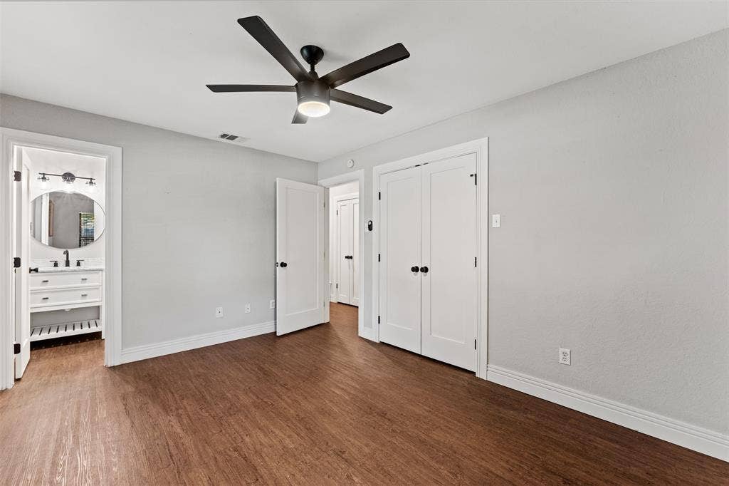 1405 Speight Avenue, #1, Waco, TX 76706 Neutral-toned room featuring wood-finish flooring, a contemporary ceiling fan, and white baseboards