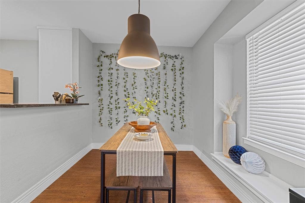 1405 Speight Avenue, #1, Waco, TX 76706 Dining area featuring wood-finish flooring, a built-in window ledge, and a modern pendant light fixture