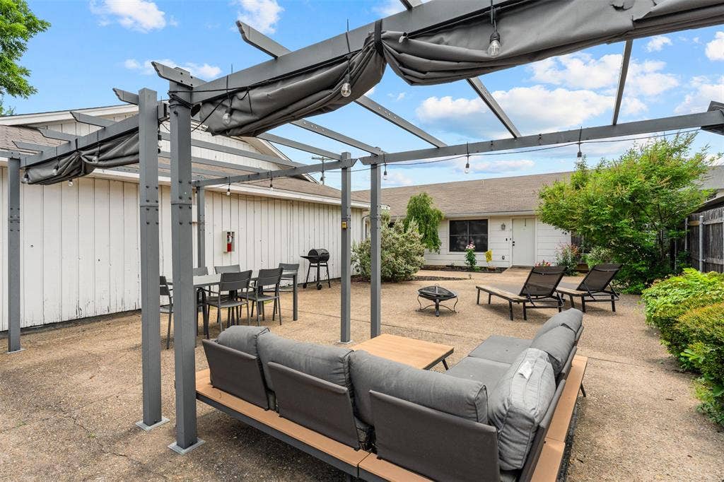 1405 Speight Avenue, #1, Waco, TX 76706 Expansive outdoor living area featuring a modern pergola with retractable canopies and string lighting