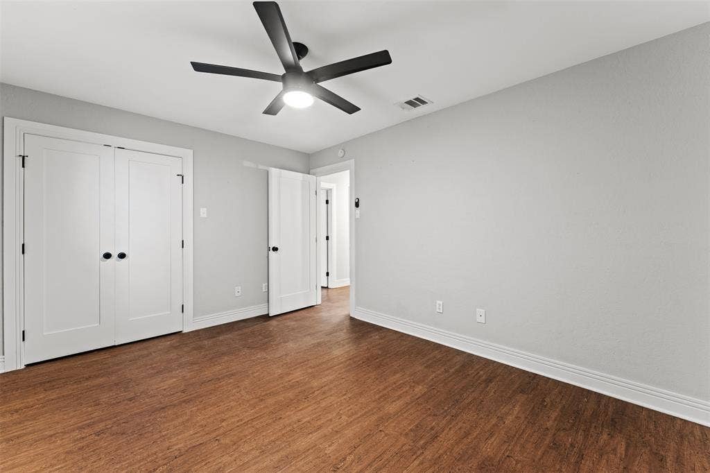 1405 Speight Avenue, #1, Waco, TX 76706 Room featuring wood-finish flooring, light grey painted walls, and white trim