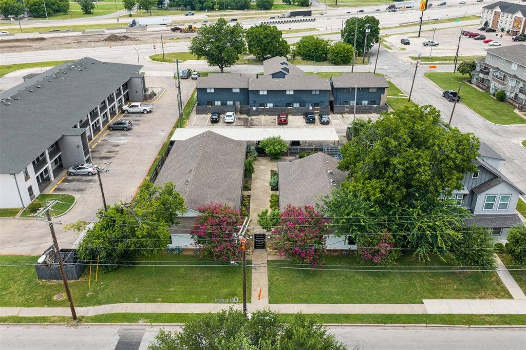 1405 Speight Avenue, #1, Waco, TX 76706 Aerial perspective showcasing multiple residential structures with gabled roofs and surrounding green spaces
