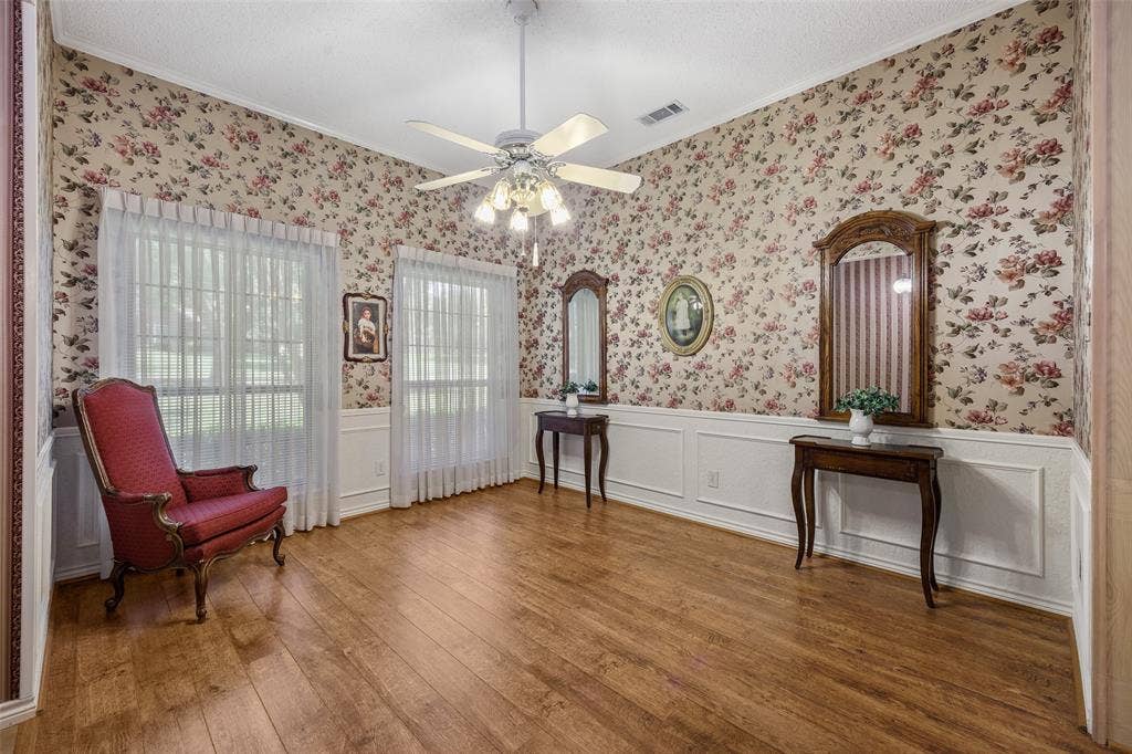 205 Covey Lane, McKinney, TX 75071 Spacious room featuring wood-finish flooring, floral wallpaper, and wainscoting