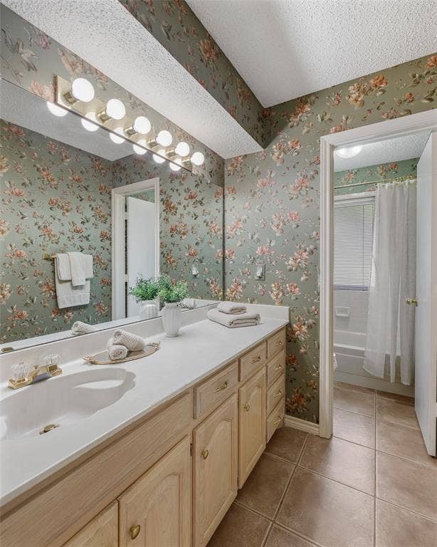 205 Covey Lane, McKinney, TX 75071 Bathroom featuring an extended single vanity with dual basins, wood-finish cabinetry, a white countertop, and a full-width mirror