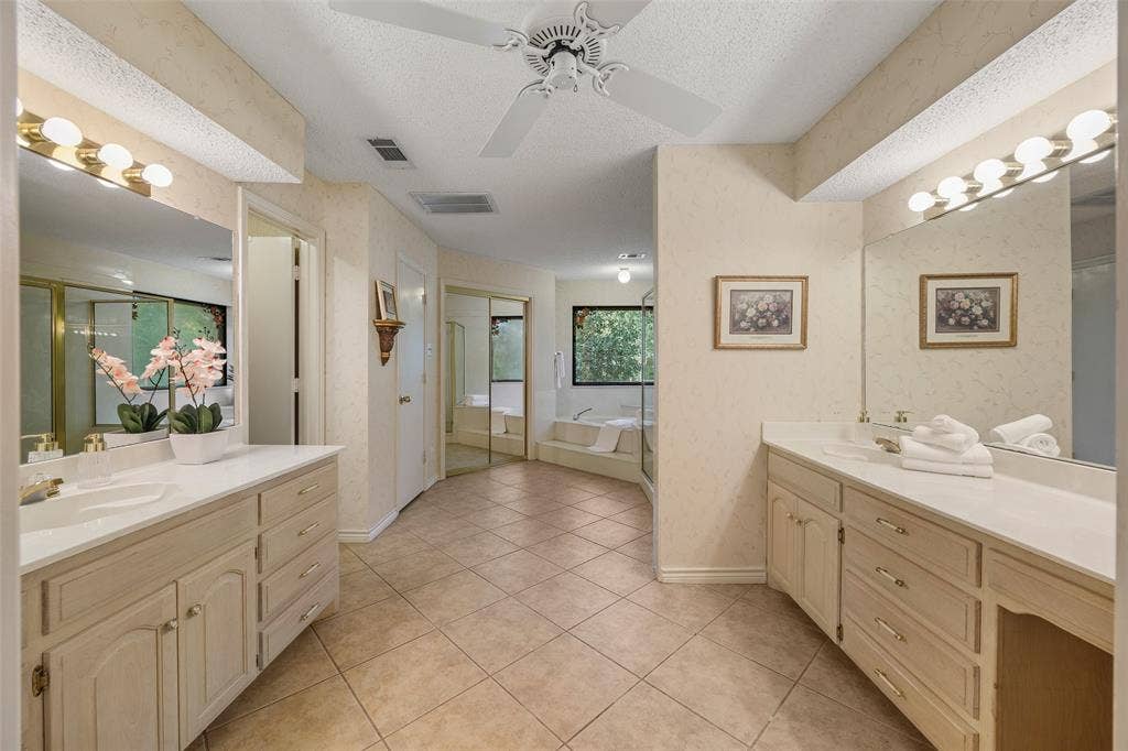 205 Covey Lane, McKinney, TX 75071 Spacious bathroom featuring dual vanities with integrated sinks, ample counter space, and extensive cabinetry