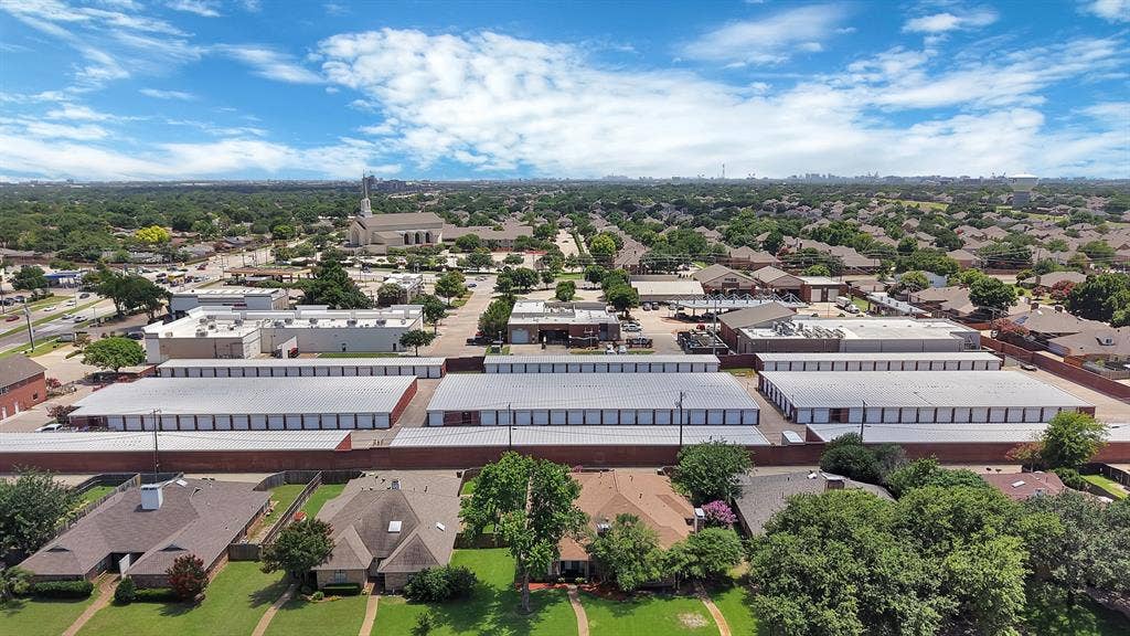 4021 San Mateo Drive, Plano, TX 75093 Aerial perspective showcasing a mixed-use neighborhood with residential properties, commercial structures, and multiple storage facilities