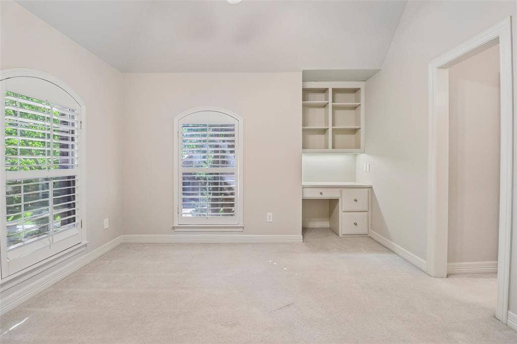 2600 Saratoga, McKinney, TX 75070 Arched windows with plantation shutters, built-in desk with task lighting, integrated shelving, and neutral wall tones