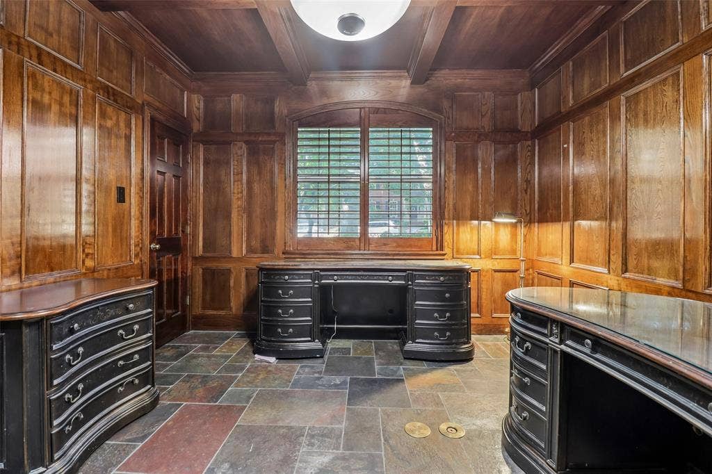 2600 Saratoga, McKinney, TX 75070 Wood paneling, coffered ceiling, stone tile flooring, and arched window with plantation shutters