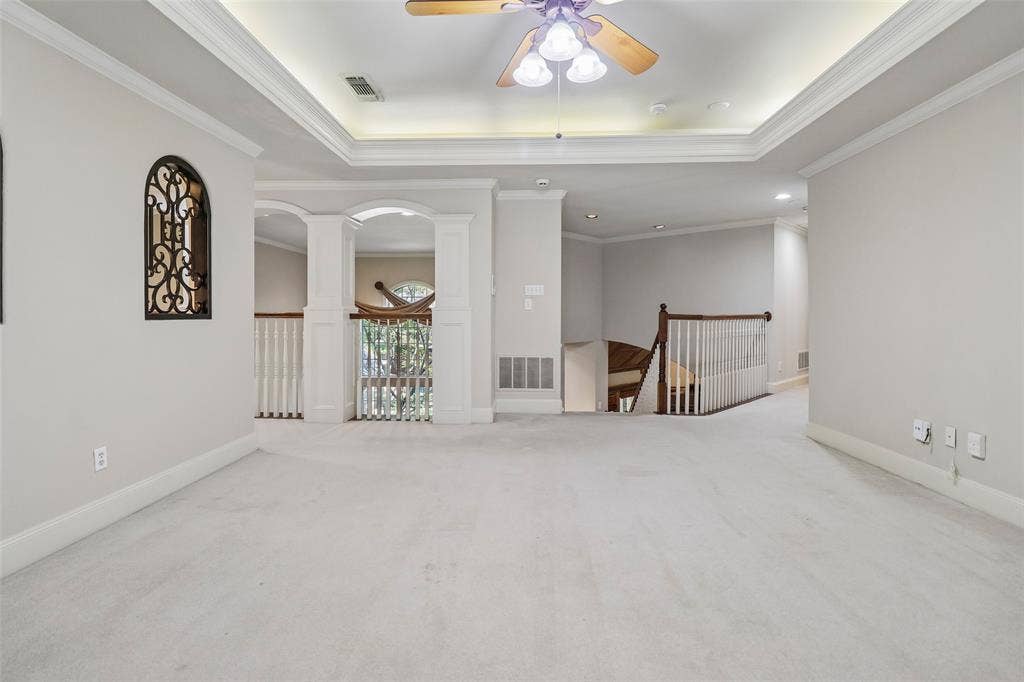 2600 Saratoga, McKinney, TX 75070 Tray ceiling with recessed lighting, ceiling fan, carpeted flooring, white balustrade, and arched openings