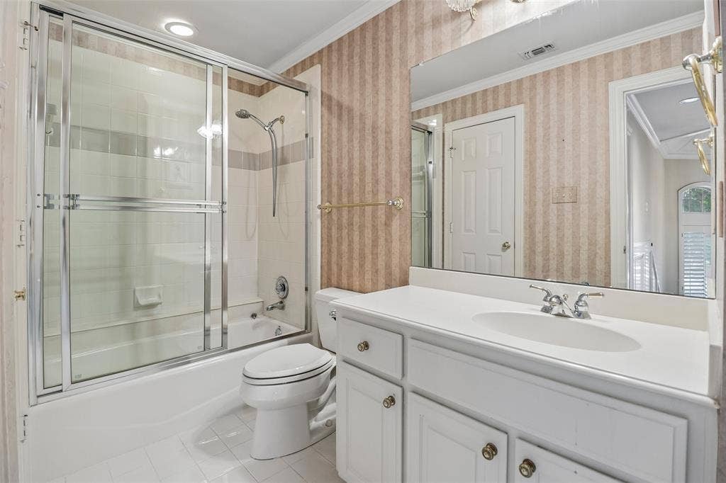 2600 Saratoga, McKinney, TX 75070 Bathroom featuring a white vanity with integrated sink, chrome-finish faucet, and a large wall-mounted mirror