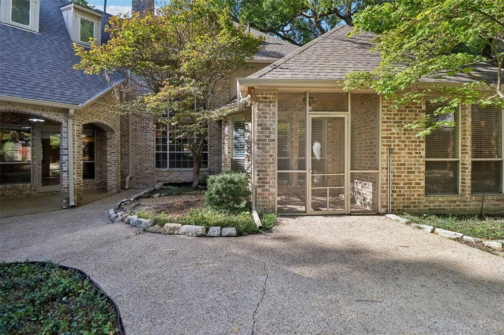 2600 Saratoga, McKinney, TX 75070 Brick exterior with covered entry portico and screened porch featuring large windows and glass doors