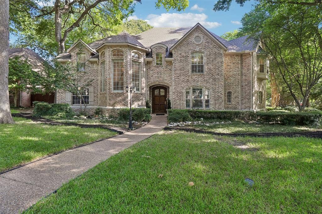 2600 Saratoga, McKinney, TX 75070 Brick exterior with multiple gables and a prominent bay window