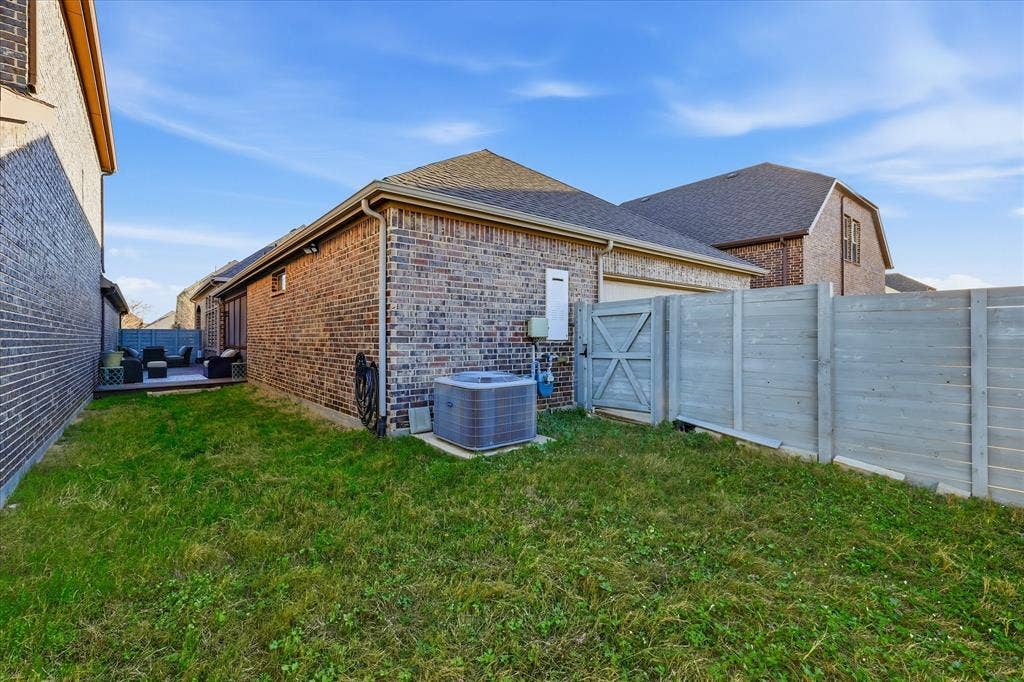 904 10th Street, Argyle, TX 76226 Fenced backyard with a wood-finish privacy fence, a grass lawn, and a wood-deck patio
