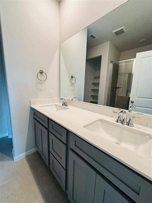 912 Santa Lucia Drive, Anna, TX 75409 Full bath featuring tile patterned flooring, double vanity, and a shower stall