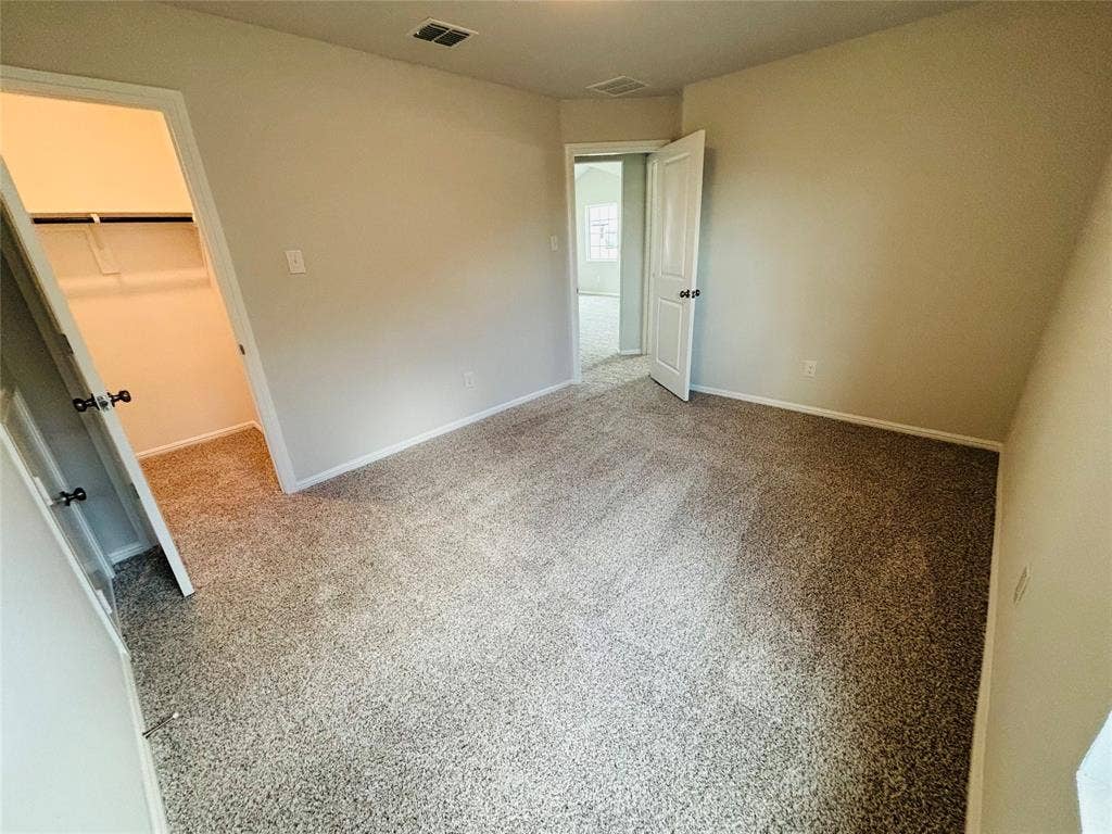 912 Santa Lucia Drive, Anna, TX 75409 Unfurnished bedroom featuring a walk in closet, carpet, and a closet