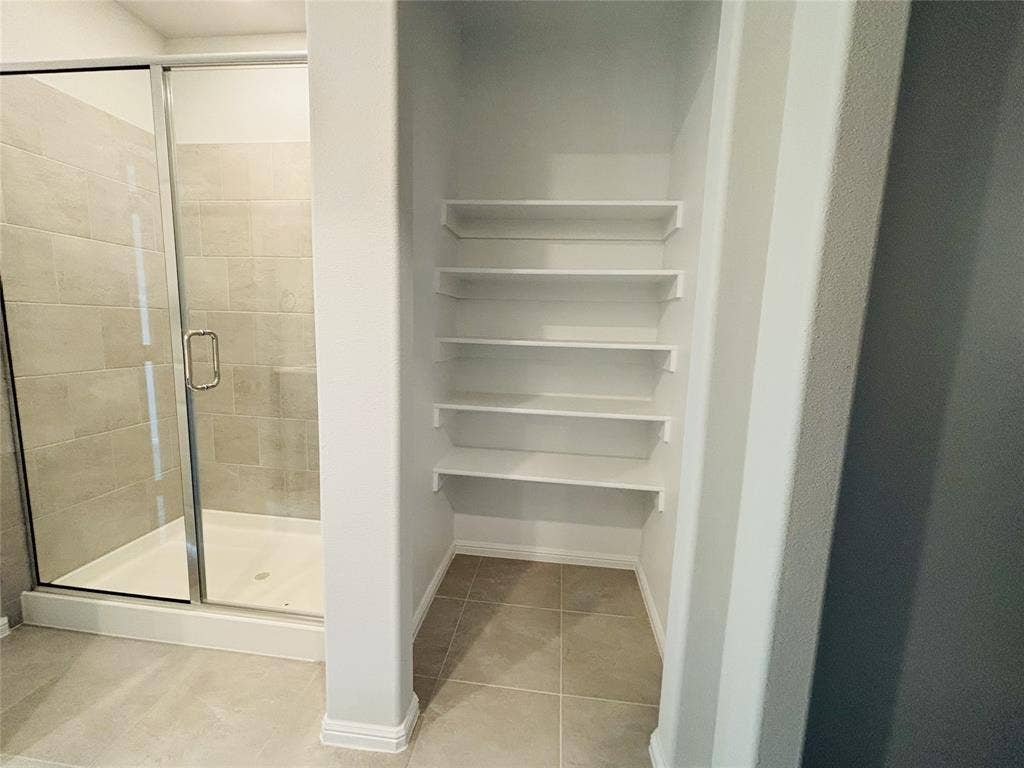 912 Santa Lucia Drive, Anna, TX 75409 Bathroom with tile patterned flooring and a shower stall