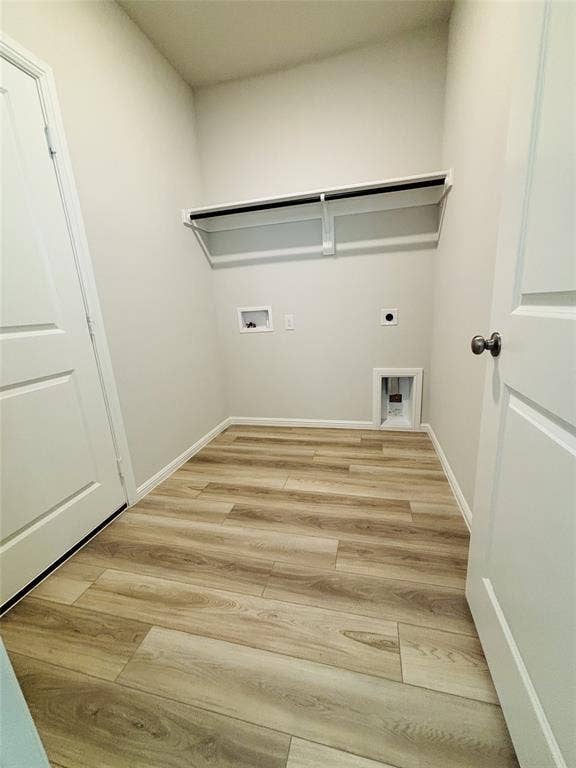 912 Santa Lucia Drive, Anna, TX 75409 Laundry room featuring electric dryer hookup, light wood-style floors, and hookup for a washing machine
