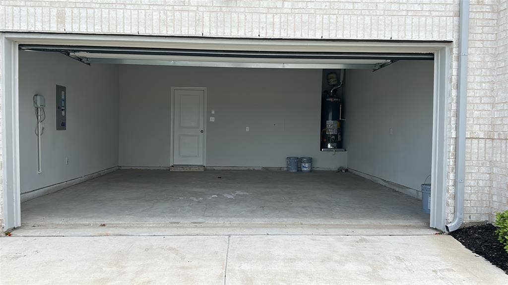 912 Santa Lucia Drive, Anna, TX 75409 Garage featuring gas water heater and electric panel