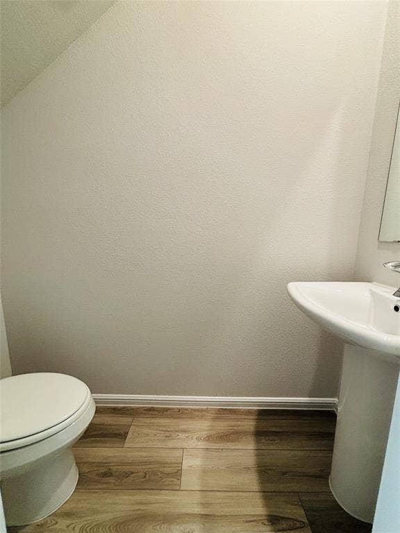 912 Santa Lucia Drive, Anna, TX 75409 Half bathroom with baseboards and wood finished floors