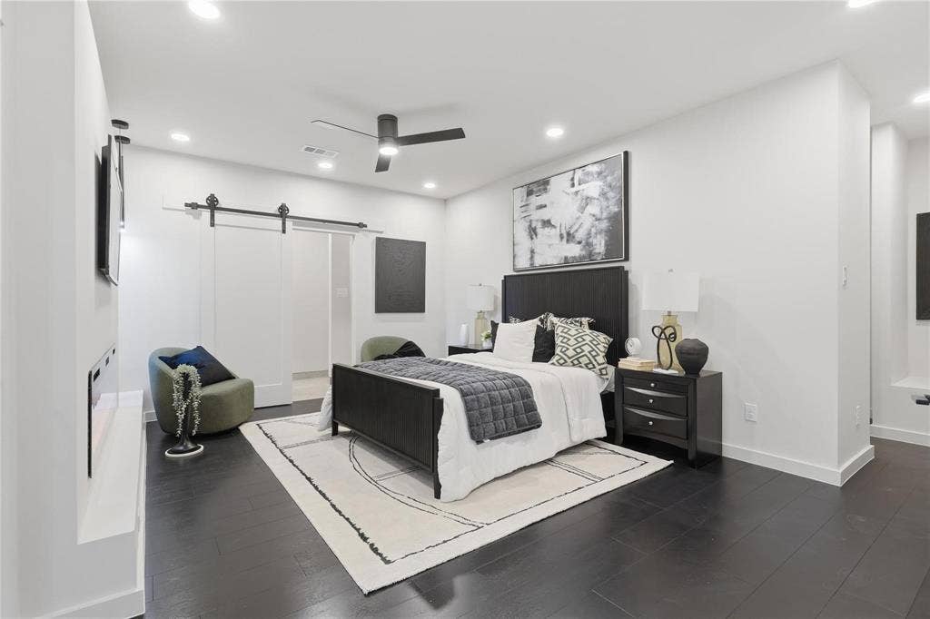 Spacious room featuring dark wood-finish flooring, recessed lighting, and a ceiling fan