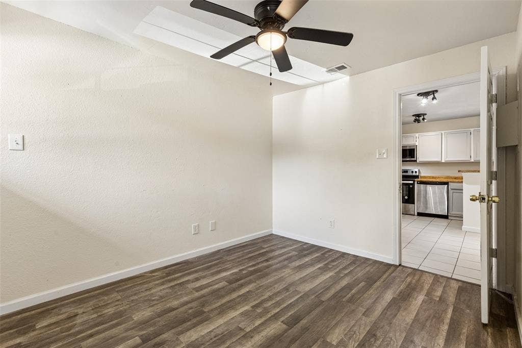 6108 Abrams Road, #610, Dallas, TX 75231 Room featuring wood-finish flooring, a ceiling fan, and white walls