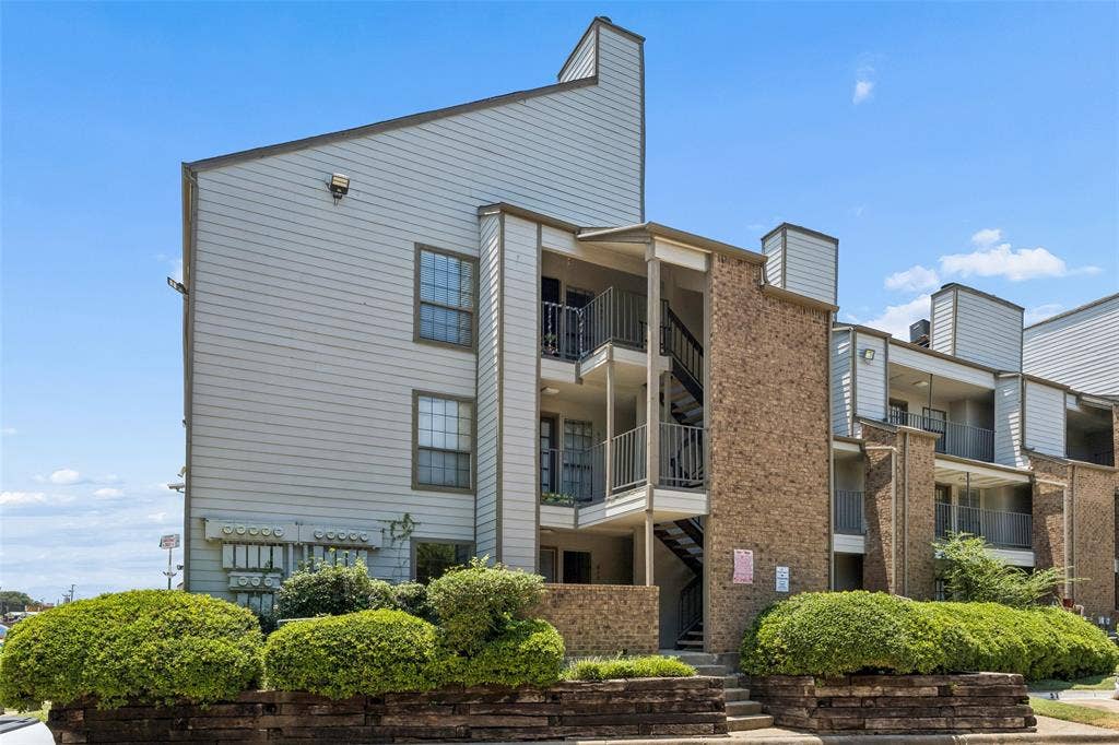 6108 Abrams Road, #610, Dallas, TX 75231 Multi-story building featuring brick and siding exteriors, private balconies with iron railings, and exterior staircases