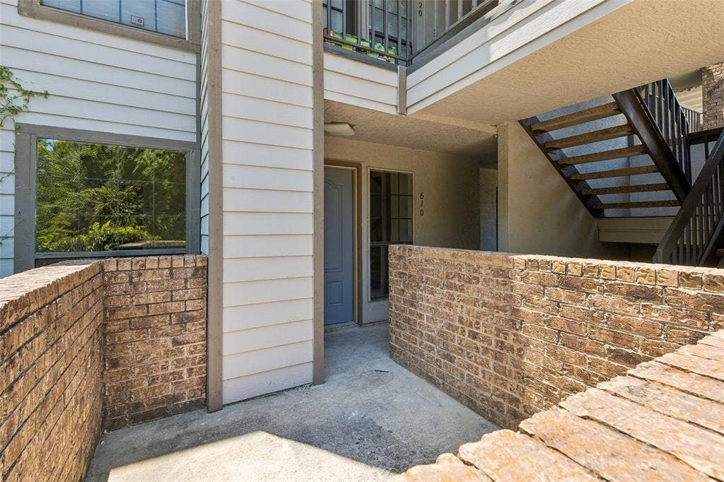 6108 Abrams Road, #610, Dallas, TX 75231 Private patio area featuring brick walls and concrete flooring