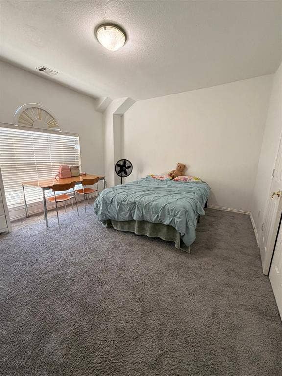 2301 Clearspring Drive S, Irving, TX 75063 Bedoom #4 featuring vaulted ceilings, a large window with horizontal blinds, a decorative arched window accent, flush-mount ceiling lighting, and wall-to-wall carpeting