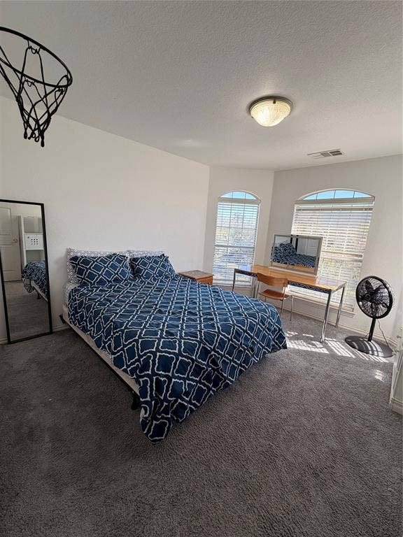 2301 Clearspring Drive S, Irving, TX 75063 Carpeted bedroom #2 featuring multiple arched windows with blinds, a ceiling-mounted light fixture, and white walls