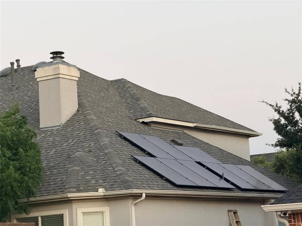 2301 Clearspring Drive S, Irving, TX 75063 Gabled roofline with dark shingle roofing and fully paid solar panel