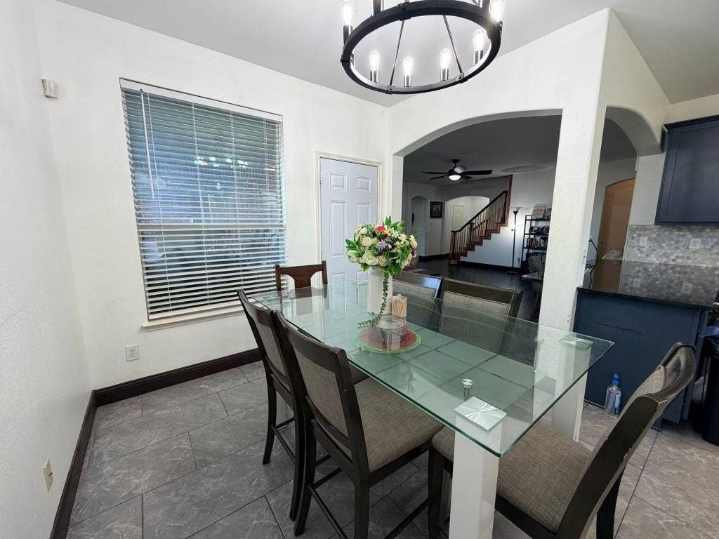 Dining area with tile flooring and a window with blinds