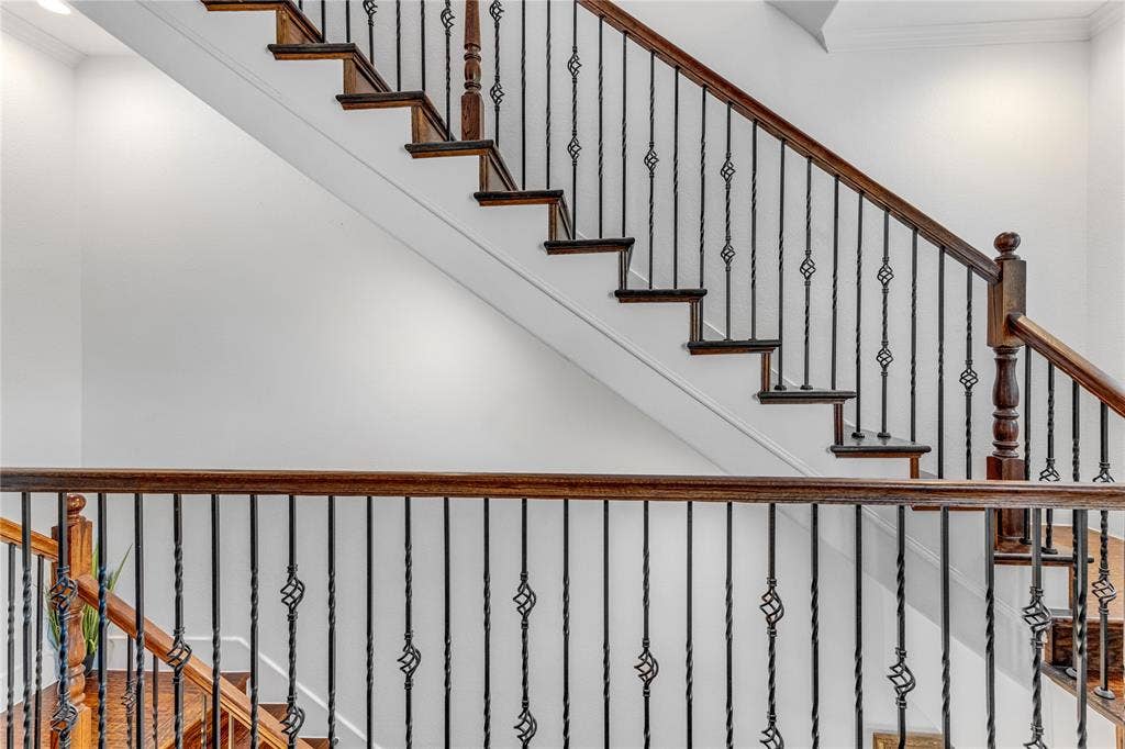 Architectural staircase featuring dark wood-finish treads and railings