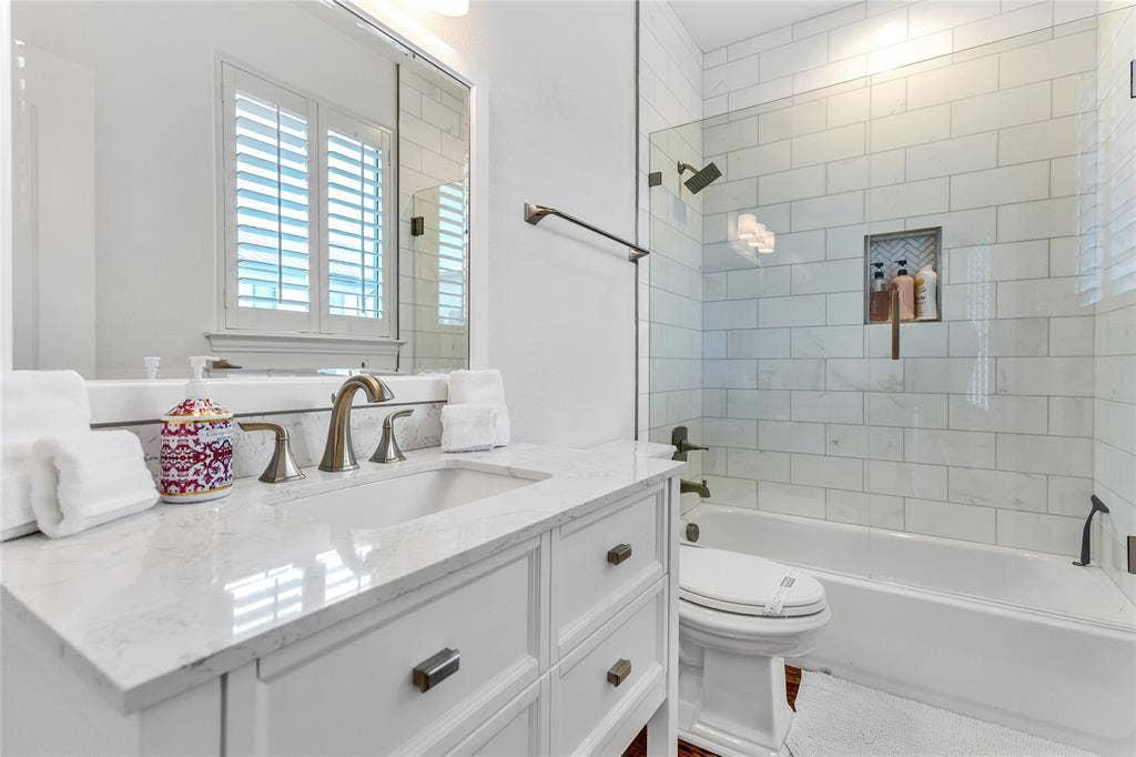 Bathroom featuring a white vanity with a rectangular undermount sink and a light-toned countertop