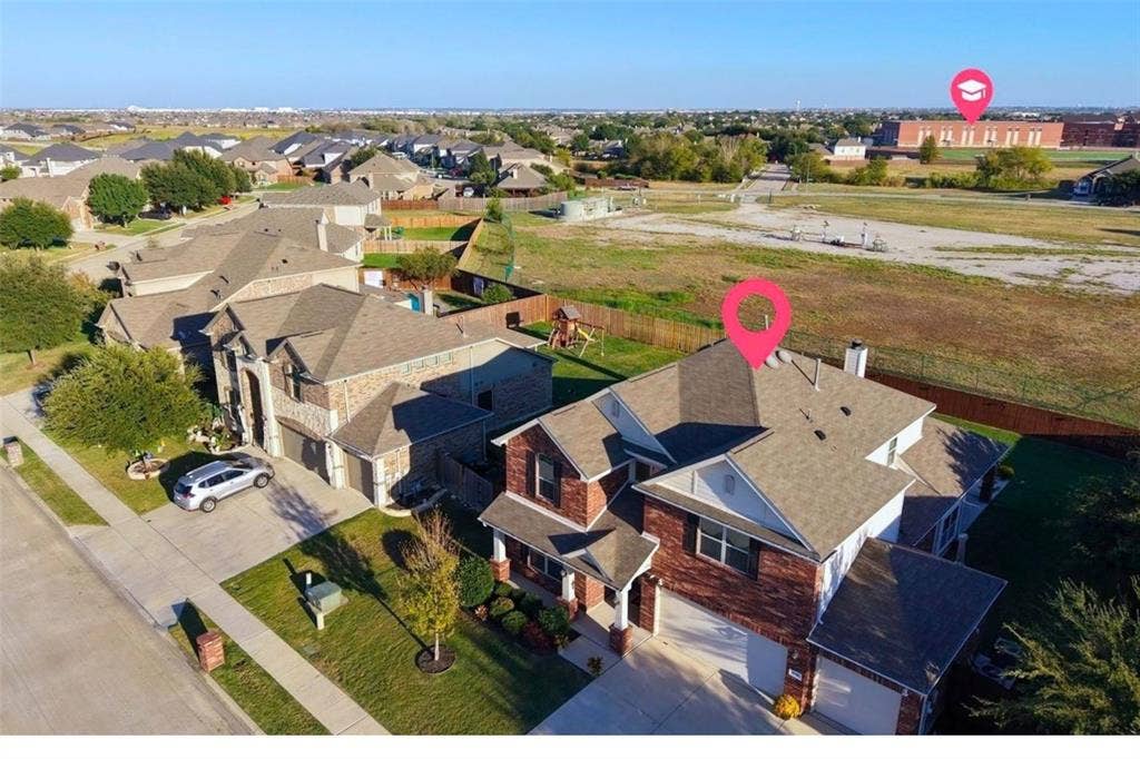 Brick and stone exterior residence with an attached two-car garage, concrete driveway, and front yard landscaping