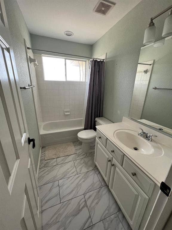 Full bathroom featuring a white vanity with integrated sink, chrome faucet, and white paneled cabinetry