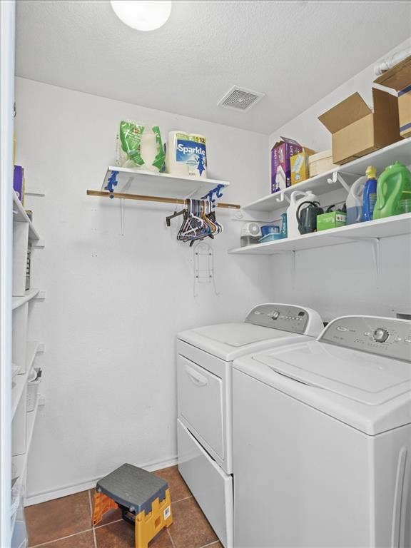1039 Wood Brook Drive, Grand Prairie, TX 75052 Dedicated utility room featuring a washer and dryer, tile flooring, built-in shelving, and a ceiling-mounted light fixture