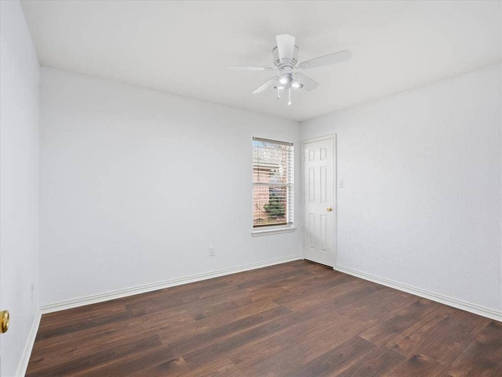 1039 Wood Brook Drive, Grand Prairie, TX 75052 Room with wood-finish flooring, white walls, and a window with horizontal blinds