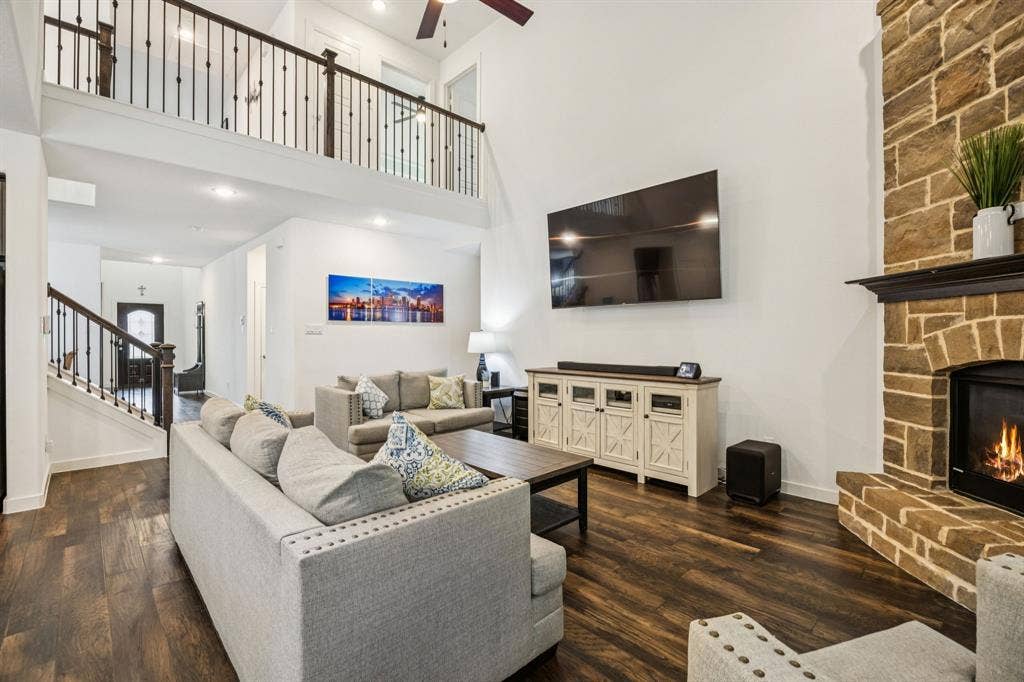 Spacious open living with gas fireplace overlooking the pool area.