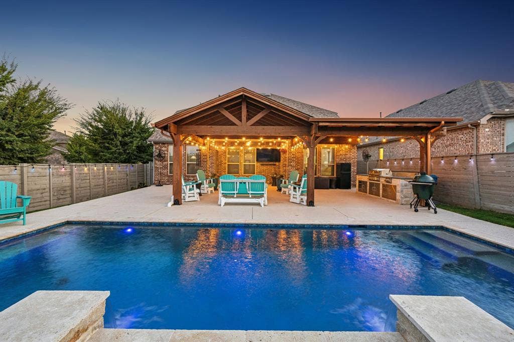 This backyard retreat has everything you need with a saltwater pool, lighting, built in grilling area and extended patio seating for entertaining.