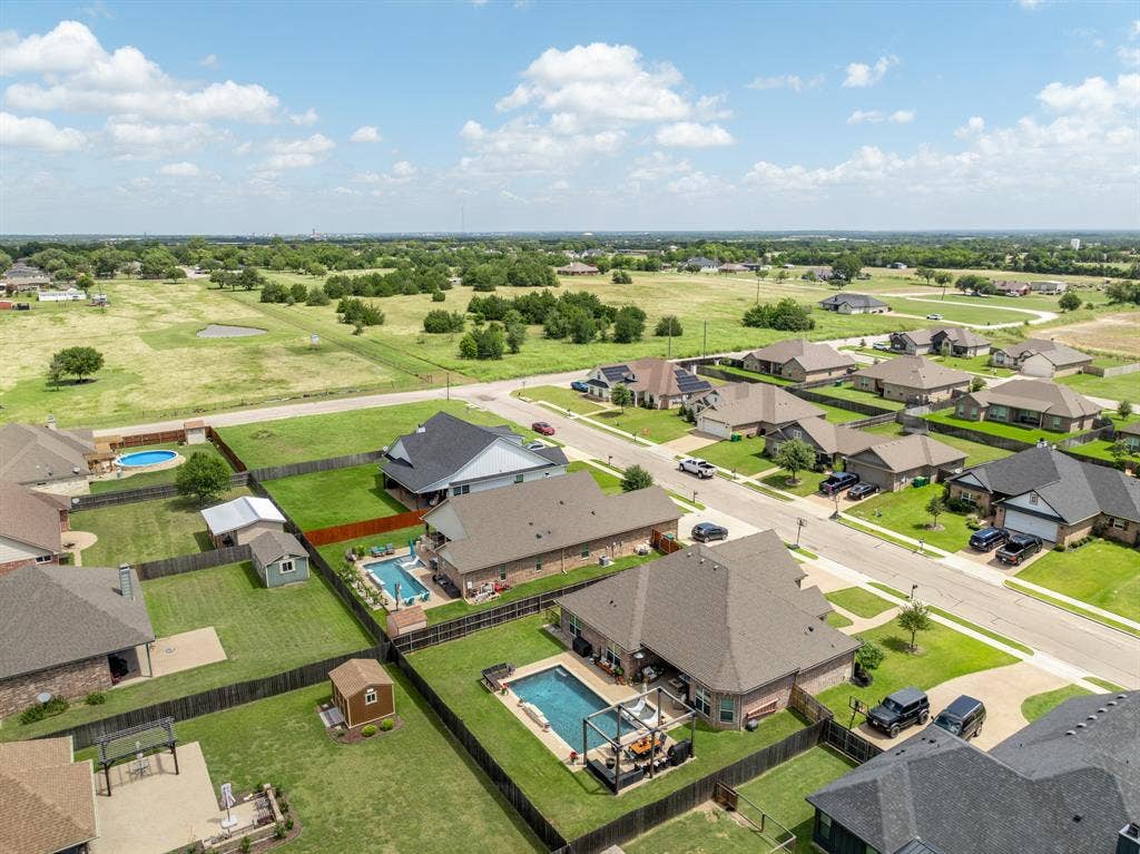 386 Cavitt Court, Robinson, TX 76706 Aerial perspective showcasing a residential community with individual homes, fenced backyards, and mature landscaping