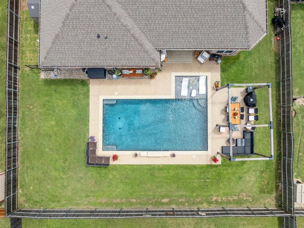 386 Cavitt Court, Robinson, TX 76706 Private backyard oasis featuring a rectangular swimming pool with integrated sun shelf