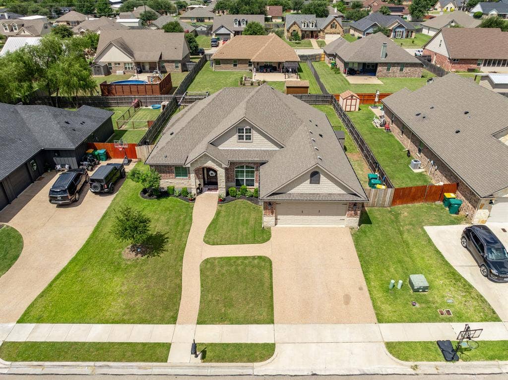 386 Cavitt Court, Robinson, TX 76706 Traditional style residence featuring a brick and siding exterior, a gabled roofline, an attached two-car garage, and a concrete driveway