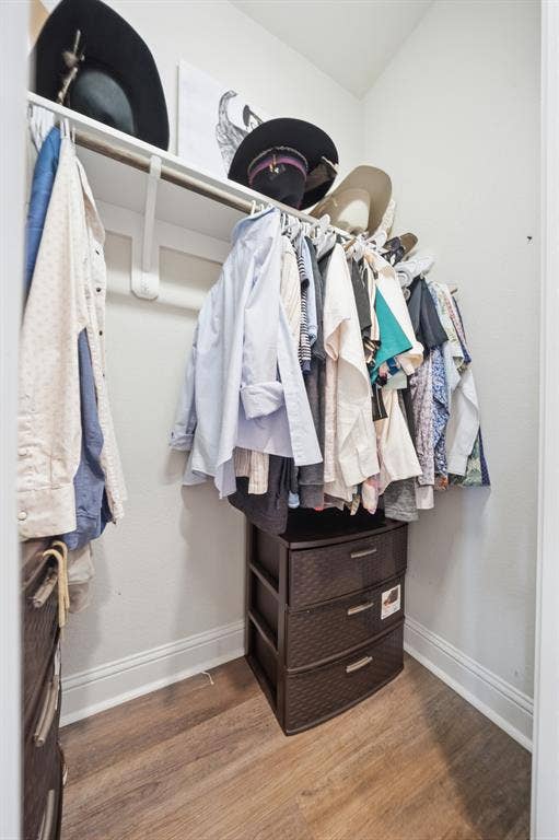386 Cavitt Court, Robinson, TX 76706 Compact closet space featuring a single hanging rod, upper shelving, and wood-finish flooring