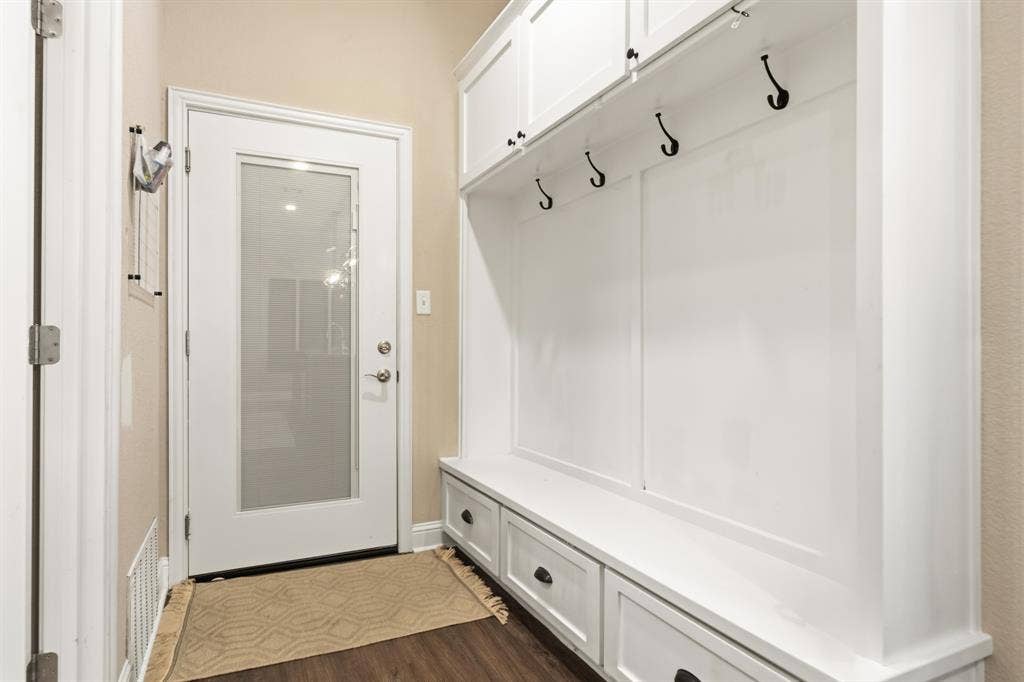 386 Cavitt Court, Robinson, TX 76706 Built-in white cabinetry with a bench and storage drawers, featuring black hooks and hardware