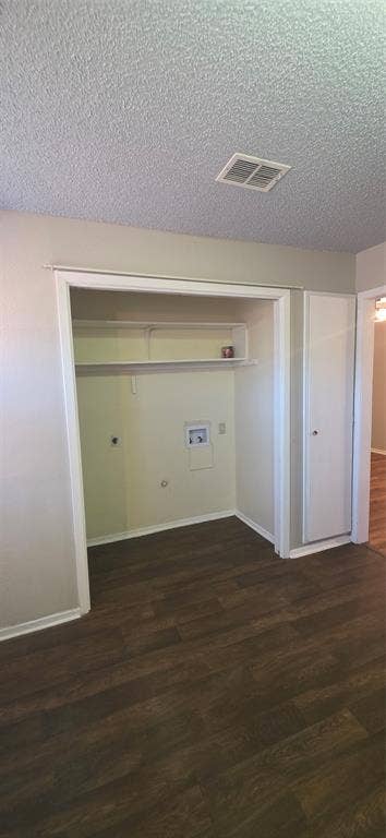 235 Vista Way, Benbrook, TX 76126 Laundry closet featuring hookups and a storage shelf, accompanied by wood-finish flooring and a white built-in cabinet
