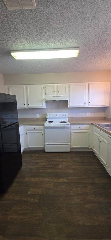 235 Vista Way, Benbrook, TX 76126 Kitchen featuring wood-finish flooring, white cabinetry, a white electric range, and a black refrigerator