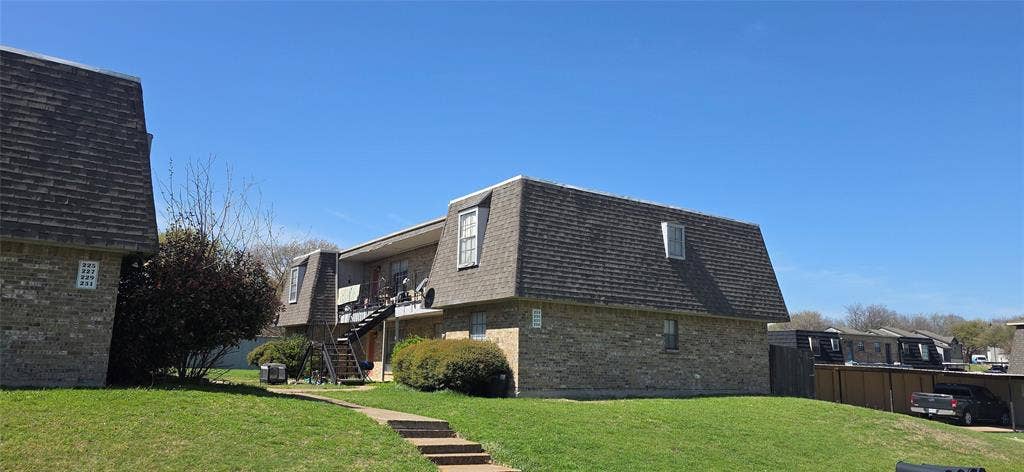 235 Vista Way, Benbrook, TX 76126 Two-story apartment building with brick facade and dormer windows