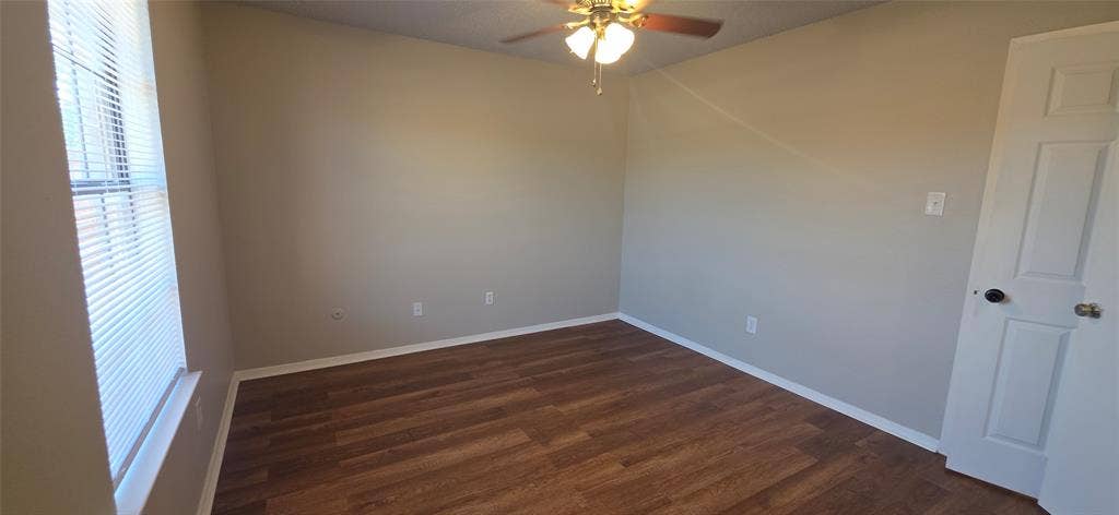 235 Vista Way, Benbrook, TX 76126 Room featuring wood-finish flooring, a ceiling fan with integrated lighting, and a paneled door