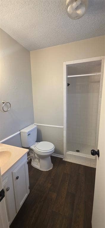 235 Vista Way, Benbrook, TX 76126 Bathroom featuring a stand-up shower, wood-finish flooring, and a vanity with cabinet storage